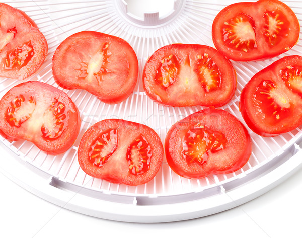 Ripe tomato on food dehydrator tray, ready to dry Stock photo © BSANI