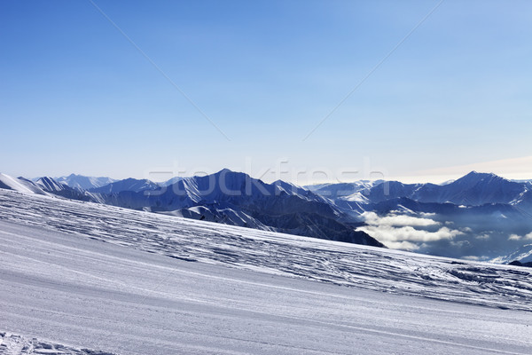 Ski slope and snowy mountain in haze Stock photo © BSANI