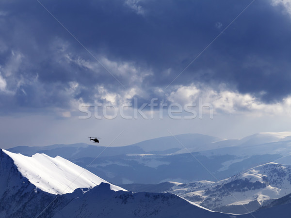 Off-piste slope for heliskiing and helicopter in evening Stock photo © BSANI