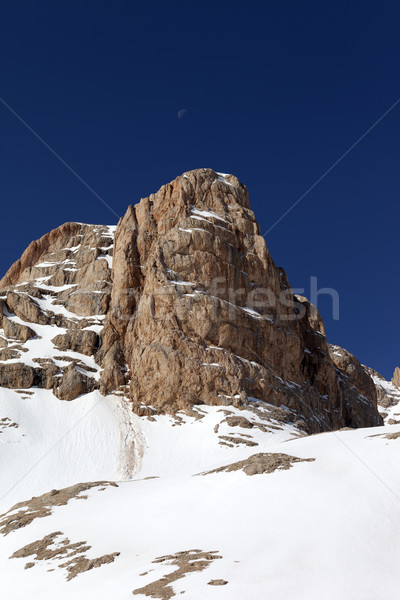 Snowy rock and cloudless sky with moon Stock photo © BSANI