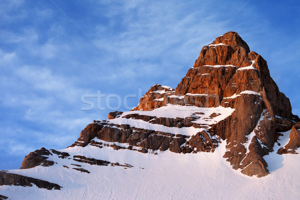 Snowy sunlight rocks at sunrise Stock photo © BSANI