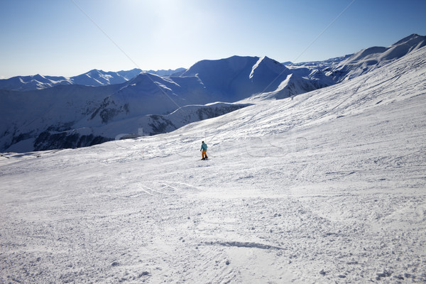 Skier on slope in sun day Stock photo © BSANI