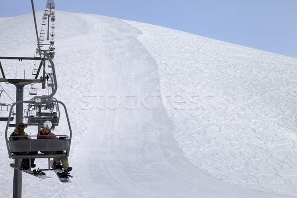 Snowboarders on chair-lift and ski slope Stock photo © BSANI