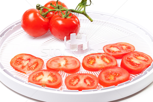 Ripe tomato on food dehydrator tray Stock photo © BSANI