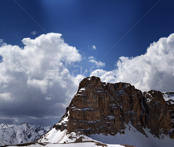 Panorama of snowy rocks and sky with sunbeam in nice spring day Stock photo © BSANI
