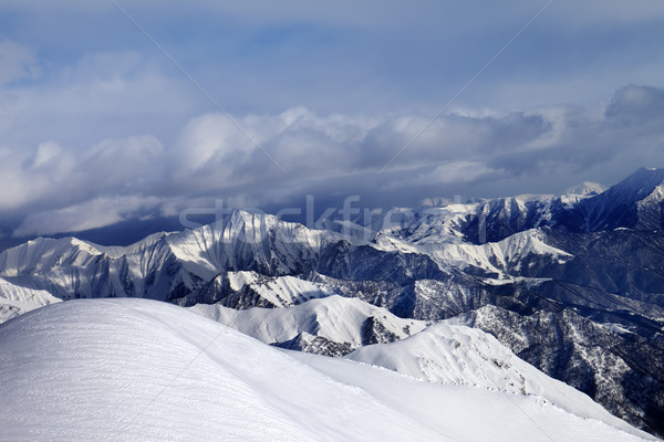 Off-piste snowy slope and mountains in cloud Stock photo © BSANI