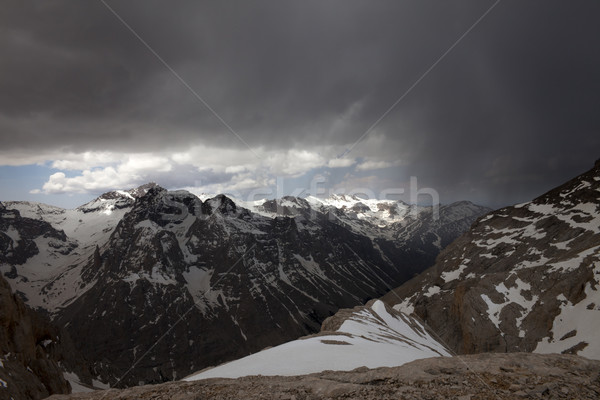 Snowy mountains and storm clouds Stock photo © BSANI