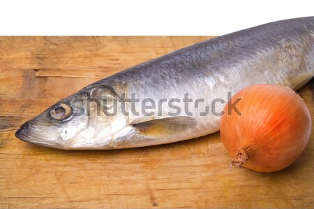 Herring with onion rings on old wooden board Stock photo © BSANI