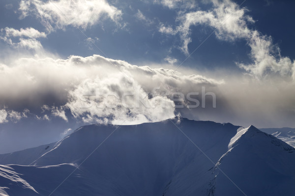 Mountains in evening and sunlit clouds Stock photo © BSANI