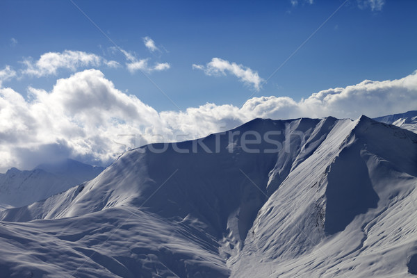 Off piste slope in evening with sunlit clouds Stock photo © BSANI