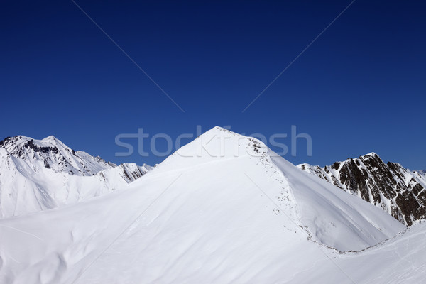 Snowy off-piste slope and blue clear sky at nice winter day Stock photo © BSANI