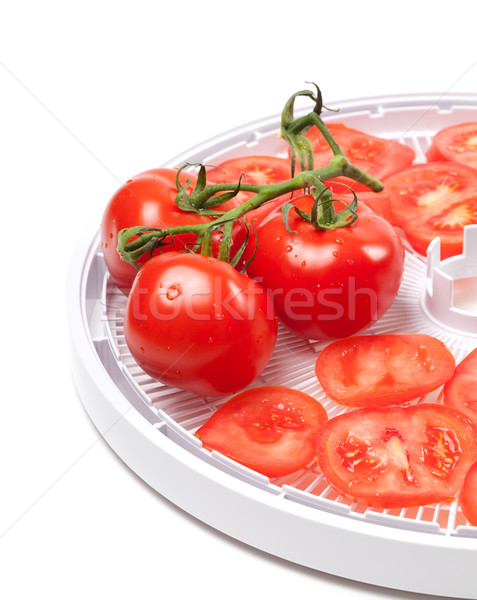 Ripe tomato on food dehydrator tray Stock photo © BSANI