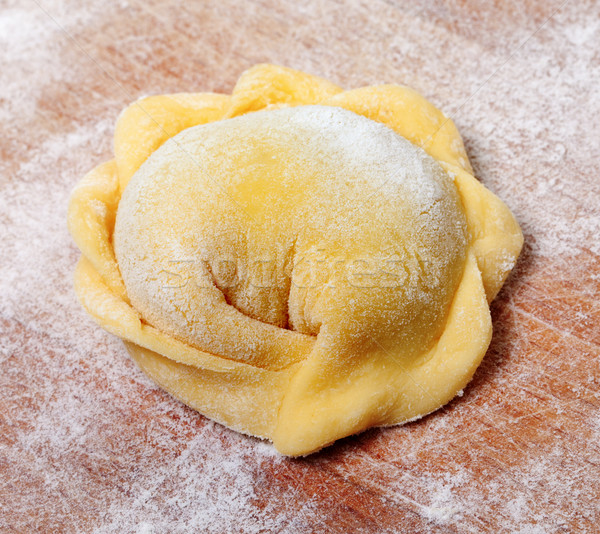 Raw ravioli on wooden cutting board Stock photo © BSANI