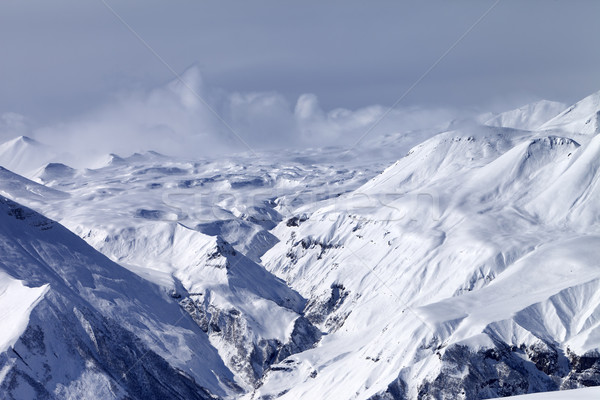 Snowy mountains in haze Stock photo © BSANI