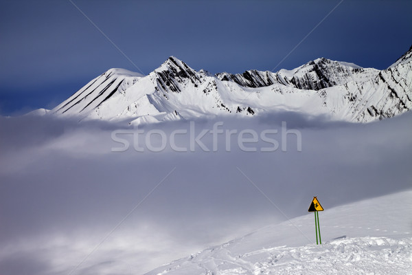 Warning sing on ski slope and mountains in fog Stock photo © BSANI