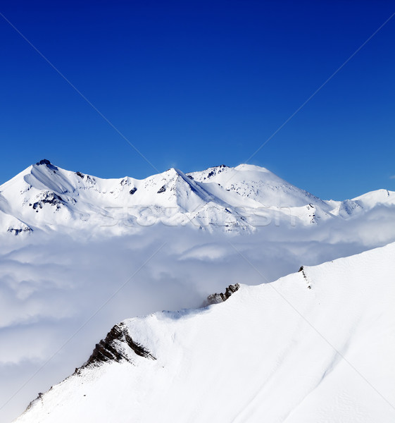 Mountains in clouds at nice day. View from ski slope. Stock photo © BSANI