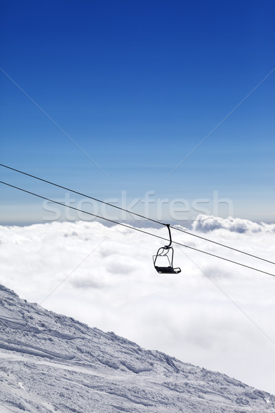 Ski slope, chair-lift and mountains under clouds Stock photo © BSANI