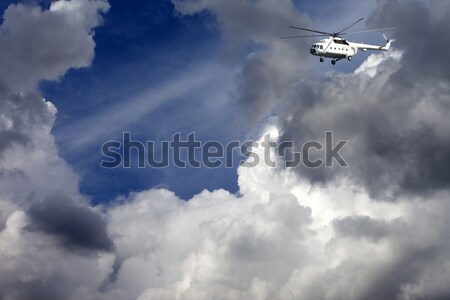 Helicopter in blue sky with clouds Stock photo © BSANI