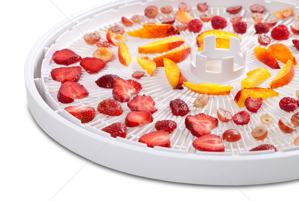 Slices of berries and fruits on dehydrator tray Stock photo © BSANI