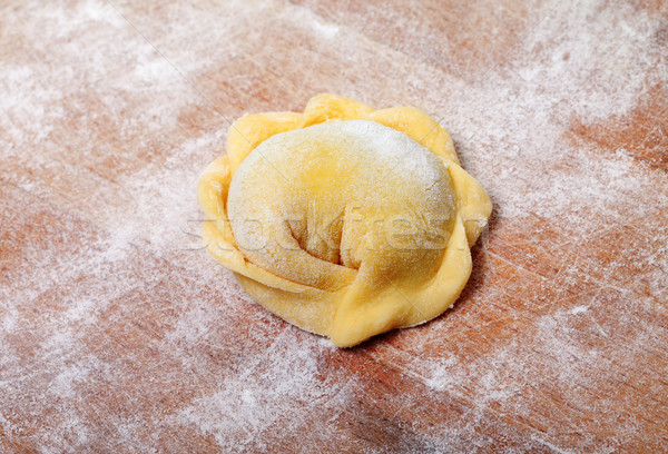 Raw ravioli on wooden cutting board Stock photo © BSANI