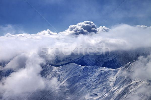 Stock photo: View on off-piste slope at mist and sunlight clouds