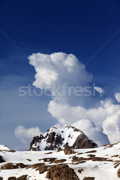 Rocks in snow and blue sky with clouds Stock photo © BSANI