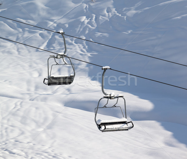 Two chair-lift with snowdrift and off-piste slope in sun morning Stock photo © BSANI