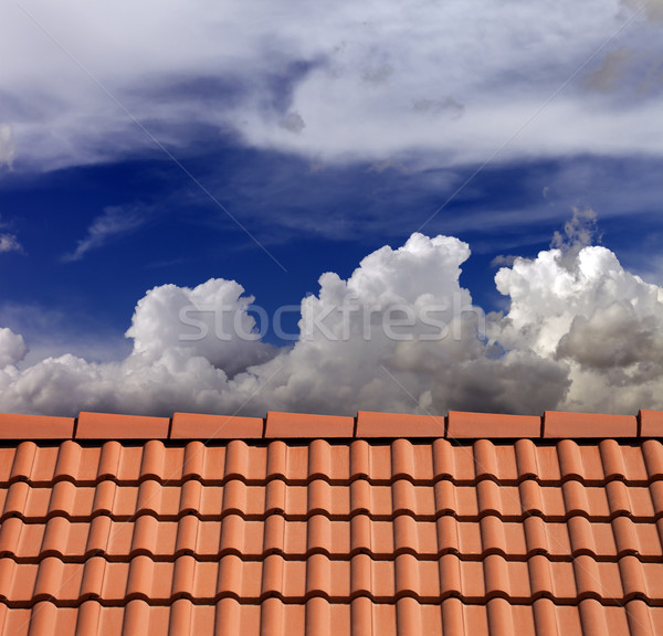 Roof tiles and blue sky with clouds Stock photo © BSANI
