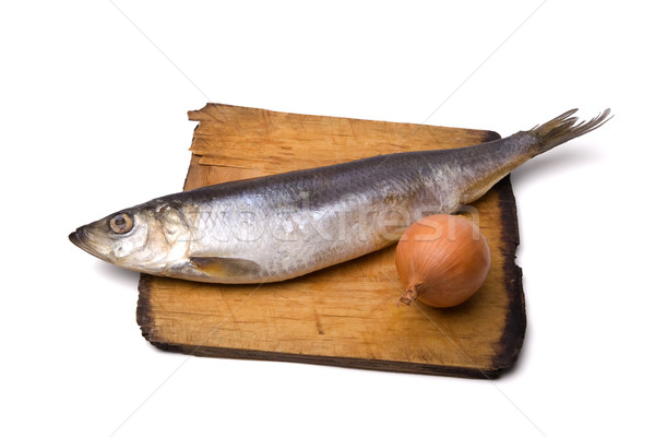 Herring with onion on old wooden board Stock photo © BSANI