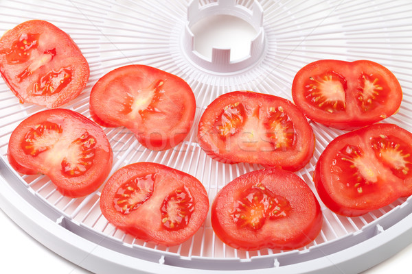 Fresh tomato on food dehydrator tray, ready to dry Stock photo © BSANI