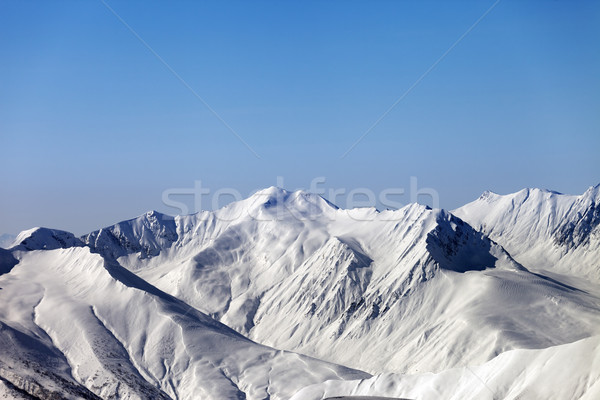 Snowy mountains and blue clear sky Stock photo © BSANI
