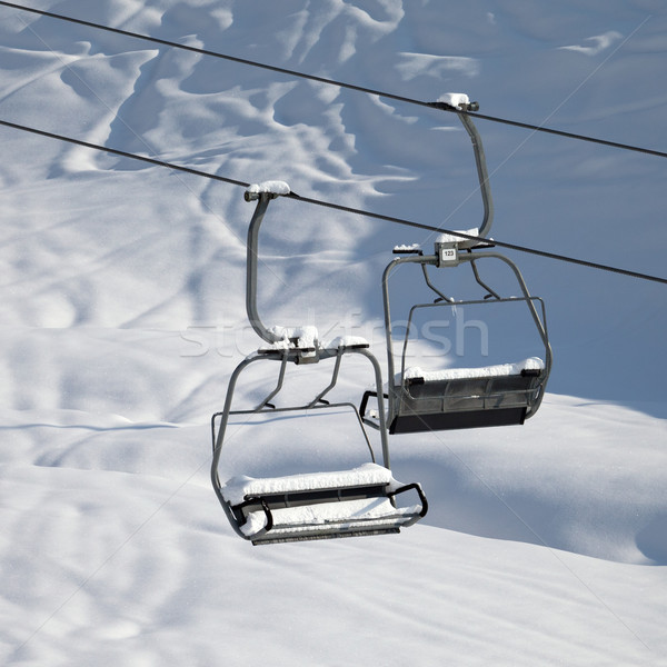 Two chair-lift with snowdrift in sun morning. Close-up view. Stock photo © BSANI