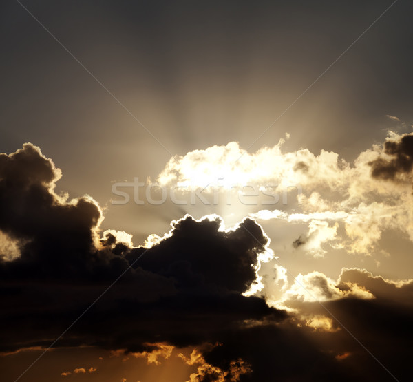 Sunset sky with dark clouds and sun rays Stock photo © BSANI