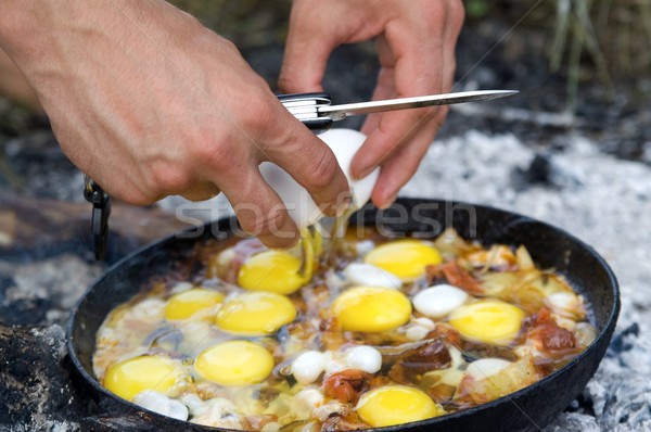 Fried eggs. Cooking on the fire Stock photo © BSANI