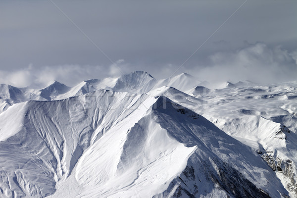 Snowy mountains in haze Stock photo © BSANI