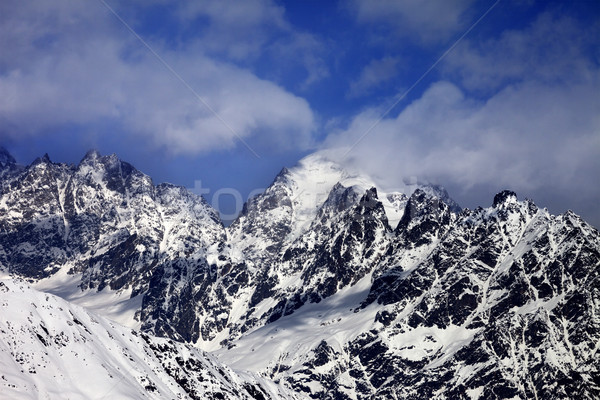 Snowy rocks in clouds at sun winter day Stock photo © BSANI