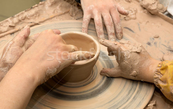 Beginner and teacher hands in clay at process of making crockery Stock photo © BSANI
