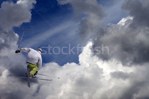 Stock photo: Freestyle ski jumper with crossed skis against blue sky with clo