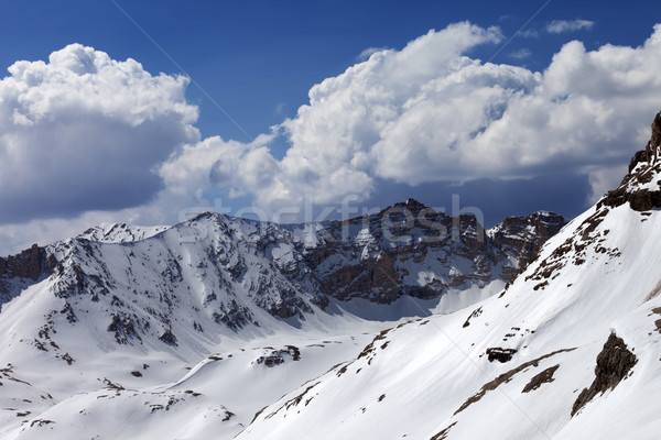 Snowy mountains and blue sky with cloud in sunny spring day Stock photo © BSANI