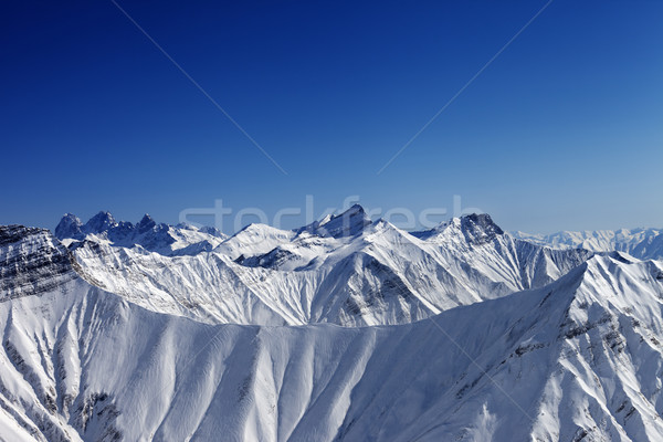 Snowy winter rocks in sun day, view from ski slope Stock photo © BSANI