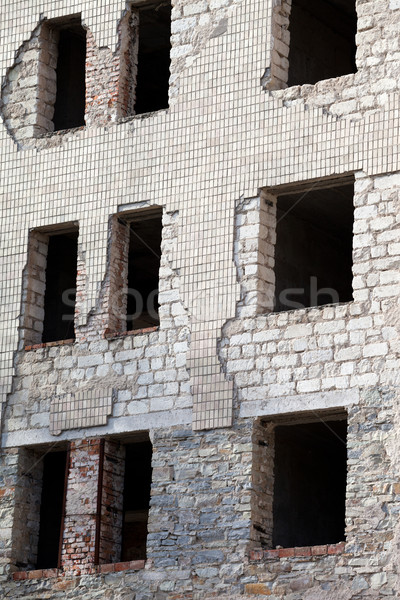 Wall of old destroyed house with broken windows Stock photo © BSANI
