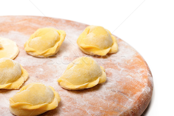 Raw ravioli on wooden cutting board Stock photo © BSANI