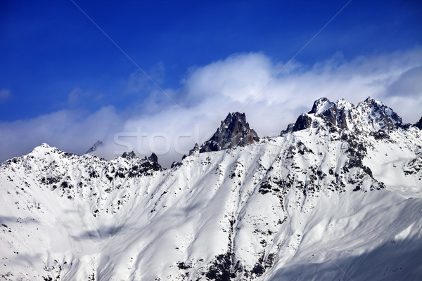 Snow avalanches mountainside in clouds Stock photo © BSANI