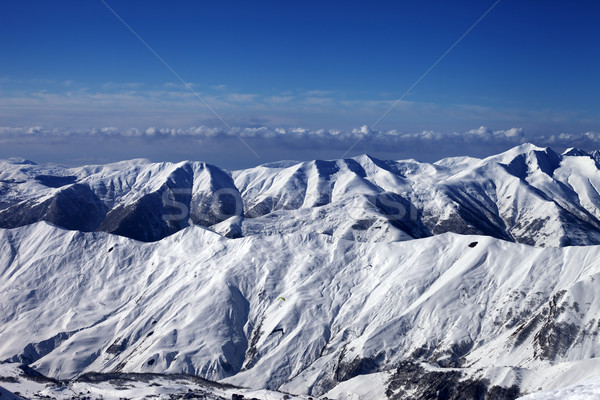 Snowy mountains and sky with clouds Stock photo © BSANI