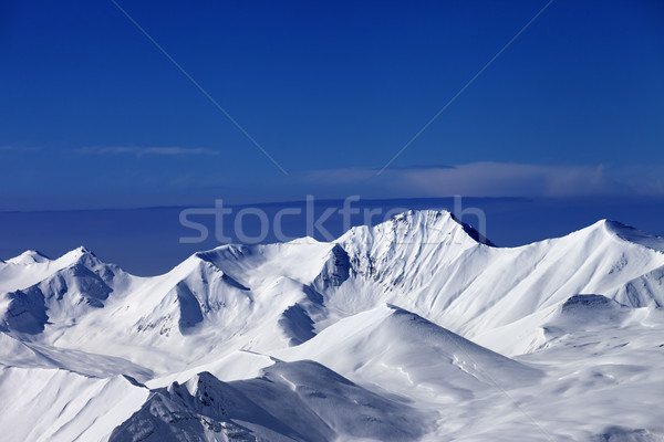 Snowy mountains at sunny day and multicolor blue sky Stock photo © BSANI