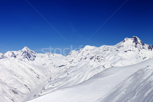 Snowy mountain peaks in sun nice day Stock photo © BSANI