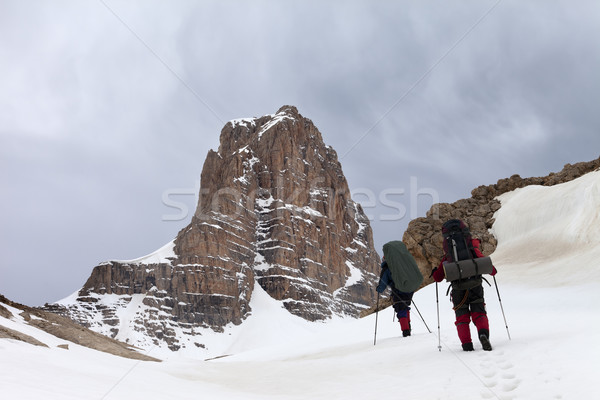Two hikers in snowy mountains before storm Stock photo © BSANI