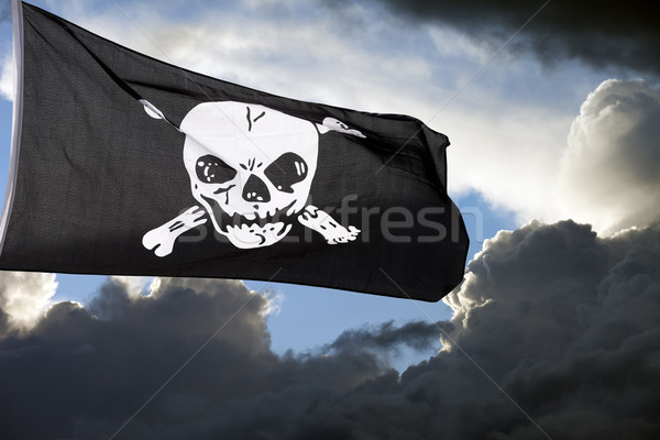Jolly Roger (pirate flag) against storm clouds Stock photo © BSANI