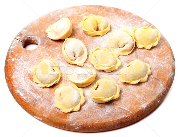 Raw homemade ravioli on wooden cutting board Stock photo © BSANI