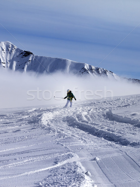 Snowboarder downhill on off-piste slope in sunny day Stock photo © BSANI